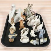 Four graduated Goebel swan candle holders, together with a Lladro figure of a swan, No.