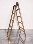 A mid-20th century pine stepladder, with metal fittings, height 232 cm.
