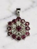 A white gold ruby and diamond pendant, the total diamond weight estimated at 1.