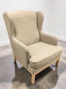 A late 20th century Scandinavian wingback armchair in oatmeal fabric, width 76 cm.