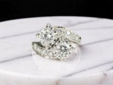 A two-stone diamond 'Toi et Moi' twist ring, the brilliant-cut stones weighing an estimated 0.