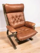 A Scandinavian stained bentwood and buttoned tan leather lounge armchair, width 78 cm.