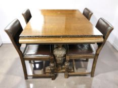 A 1920's heavily carved pull-out extending dining table, extended 200 cm x 92 cm x 80 cm,