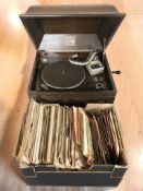 An HMV oak cased gramophone and a quantity of 78s and singles.
