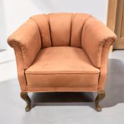 A 20th century horseshoe shaped armchair in salmon suede fabric, on beech cabriole legs,