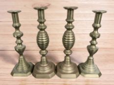 Two pairs of antique brass candlesticks, tallest 32 cm.
