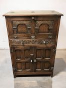 A 20th century oak cocktail cabinet, 77 cm x 47 cm x 115 cm.