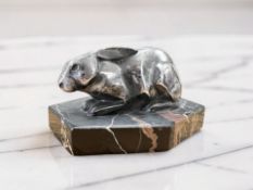 An Art Deco chrome figure of a rabbit, on hexagonal marble plinth, length 9cm.