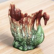 A large Majolica planter in the form of a swan, height 45 cm, stamped 555H to underside.