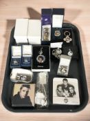 A group of Elvis Presley collectibles including cigarette case, pendants, dress rings, pocketwatch,