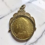 A George II guinea 1758, in 9ct gold pendant mount CONDITION REPORT: 14.