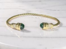A gold cabochon emerald and diamond torque bangle, inner width 6.5cm.