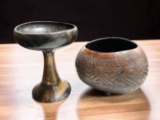 A carved wooden Calabash bowl, diameter 26 cm, together with a further hardwood pedestal bowl.