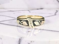 A two-tone diamond-set ring, stamped 10K,