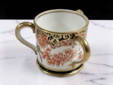 A small Royal Crown Derby Imari loving cup, with three handles, diameter 6.5 cm.