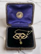 Ad Edwardian pink topaz, split pearl, and peridot brooch, stamped 15C, width 3.2cm.