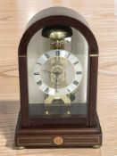 A reproduction mantel clock retailed by Sewills, Liverpool, with skeletonised movement,