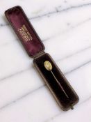 A Victorian gold stick pin set with an old cut diamond,