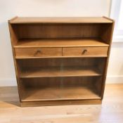 A Nathan teak sliding glass door bookcase, 103 cm x 31 cm x 107 cm.