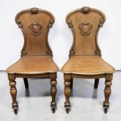 A pair of Victorian walnut hall chairs, height 88 cm.