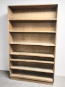 An early 20th century pine open bookcase, 127 cm x 29 cm x 207 cm.