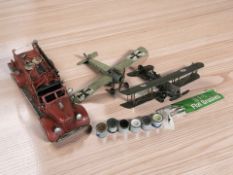 A tin plate model of a fire engine, two further planes, several small tins of modelling paint.