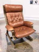 A Scandinavian stained bentwood and buttoned tan leather lounge armchair, width 78 cm.