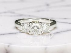 An 18ct white gold and platinum three-stone diamond ring, the stated total diamond weight 0.