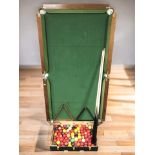A 5ft 4 folding snooker table with cues, balls, etc.
