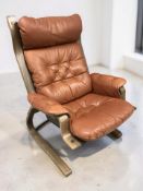 A Scandinavian stained bentwood and buttoned tan leather lounge armchair, width 78 cm.