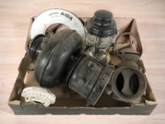 A vintage pressure cooker, storm light, railway lantern, etc.