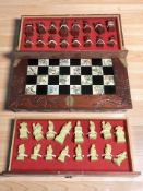 A Chinese chess set with carved wooden and pen work folding board, width 46 cm,