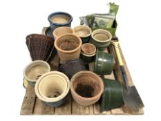 A quantity of mainly earthenware garden plant pots, garden bags, a spade, etc.
