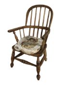 A child's elm Windsor commode armchair, height 63 cm.