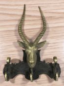 A cast brass coat rack surmounted by a deer's head, height 61 cm.