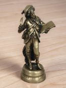 A cast brass figure of a boy with quill and parchment, height 39 cm.