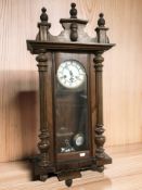 A walnut cased Junghans wall clock, with pendulum and key, height 84 cm.