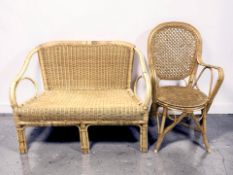 A wicker two seater settee, width 105 cm, and an armchair.