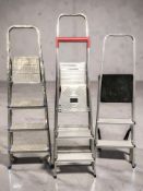 Four aluminium step ladders.