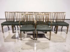 A set of eight continental beech spindle back chairs comprising two carver armchairs and six