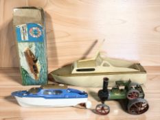 A Mamod TE1 steam tractor and a scale model electric cabin cruiser.