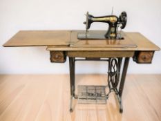 A Singer treadle sewing machine in oak table.