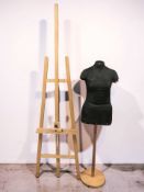 A wooden easel and a mannequin torso on stand.