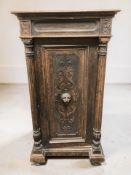 A 19th century carved oak single door pedestal cabinet, 70 cm x 54 cm x 133 cm.