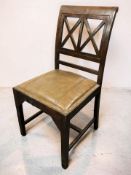 A mahogany dining chair with studded leather seat.