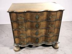 A 19th century continental oak serpentine four drawer chest on bun feet, 114 cm x 61 cm x 112 cm.