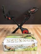 A Pleny exercise bike and a Wonder Core exerciser in box.