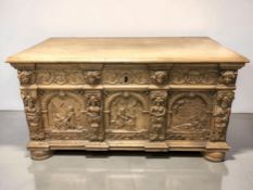 A 19th century heavily carved oak blanket chest, with cast iron handles, 125 cm x 62 cm x 68 cm.
