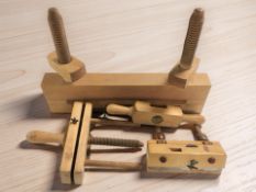 A group of vintage wooden vices.