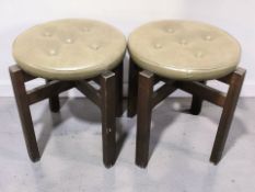 A pair of contemporary buttoned vinyl circular stools, diameter 42 cm.
